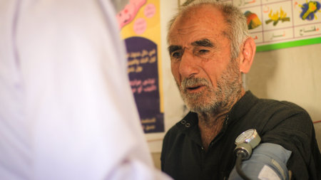 Aleppo, Syria, February 19, 2020:A sick elderly person talks with the doctor