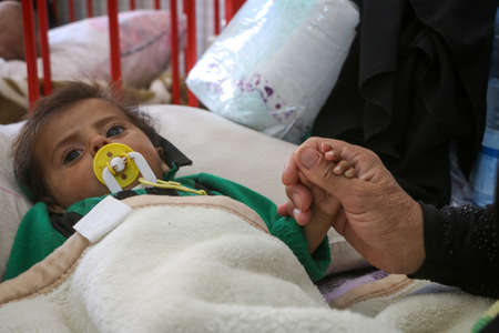 A mother afraid for her sick son, a mother holding her sonâs hand.
Aleppo, Syria 01 October 2020のeditorial素材