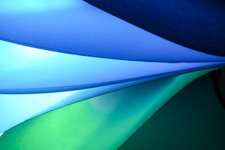 abstract background of blue and green curved sheets of paper, macro