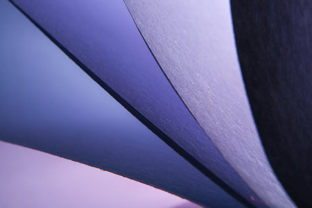 Close up of a blue and purple curved sheet of paper. Abstract background.