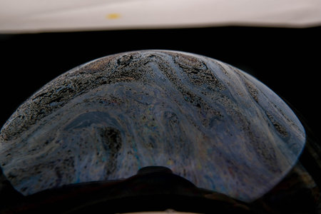 closeup photo of colored light reflection on the surface of soap bubble