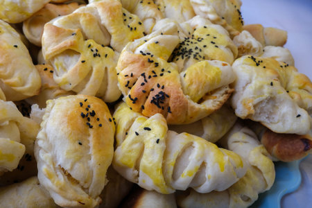 Puff pastry with sesame seeds on a plate, close upの写真素材