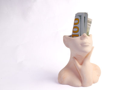 A Bust Statue with One Hundred Dollar Bills in Its Headの写真素材