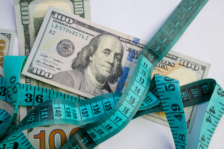 Basra, Iraq - August 5, 2025: A Measuring Tape and Money for Weight Loss and Healthcare