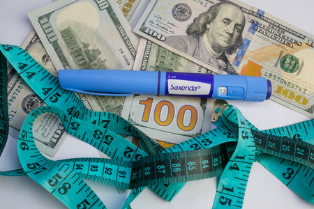 Basra, Iraq - August 5, 2025: Saxenda Pen and Money for Weight Loss and Healthcare Expensesの写真素材