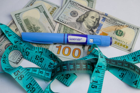 Basra, Iraq - August 5, 2025: Saxenda Pen and Money for Weight Loss and Healthcare Expenses