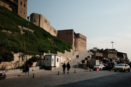 People walking near an ancient fortress with a cobblestone street.の写真素材