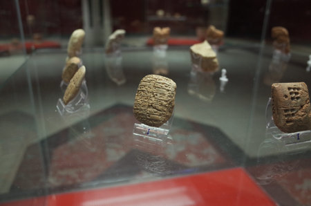 Ancient clay tablets displayed in a glass case, showcasing cuneiform writing and historical...