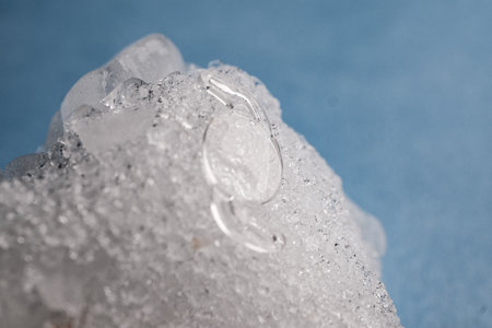 Macro View of a Clear, Flexible, Hydrophobic Intraocular Lens Precisely Positioned on Crystalline Ice for Advanced Ophthalmic Surgical Marketing and Educationの写真素材