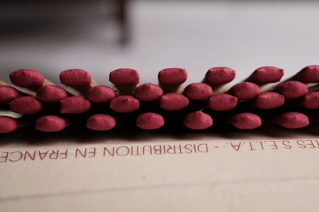 A Detailed, Shallow Depth-of-Field Macro Shot of Uniformly Arranged, Deep Crimson Match Heads