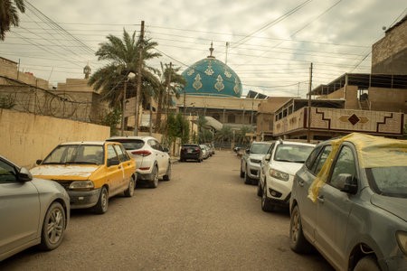 A Scenic View of a Beautiful Blue Domed Mosque with Arabic Calligraphy Located in a Busy Urban...