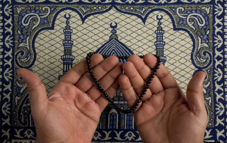Muslim prayer beads in the hands of a Muslim man against the background of the mosque