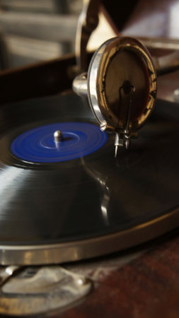 A close-up view of a vintage gramophone playing a vinyl record, showcasing the needle and spinning...