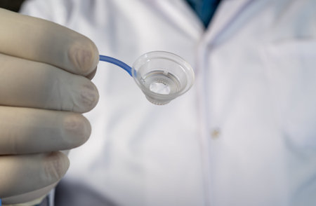 Healthcare professional showing treatment cup for refractive vision correction