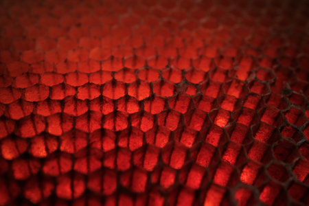 Abstract macro close-up of red animal skin scales with dramatic lighting and shallow depth of field,...