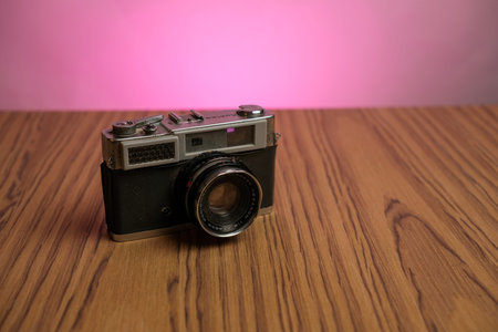Basra, Iraq- March 03, 2026: Vintage Konica Rangefinder Camera with Hexanon Lens on Wooden Surface