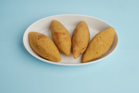 Four Fried Golden Kibbeh Appetizers Served on a White Plateの写真素材
