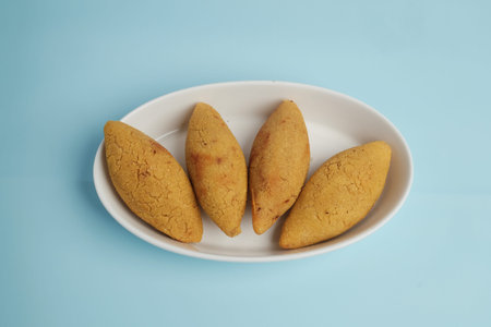 Four Fried Golden Kibbeh Appetizers Served on a White Plateの写真素材