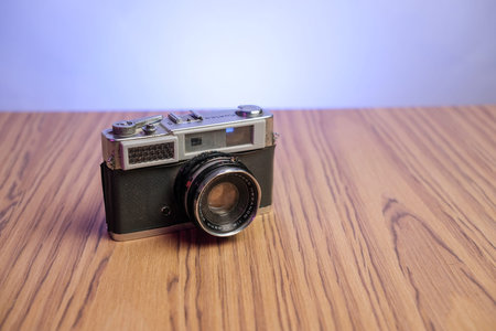 Basra, Iraq- March 03, 2026: Vintage Konica Rangefinder Camera with Hexanon Lens on Wooden Surface