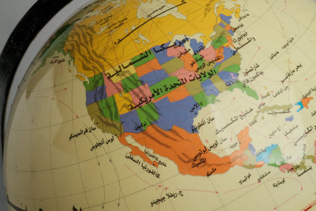 Close-up of a globe showing North America, focusing on the United States with colorful state...