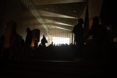 Cairo, Egypt- February 01, 2026: Silhouettes of Visitors Ascending the Monumental Grand Staircase at...