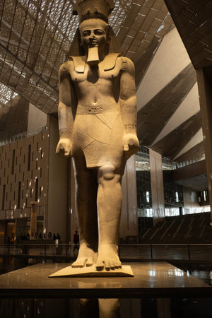 Cairo, Egypt- February 01, 2026: Majestic Statue of Ramses II Reflected in Atrium Pool at Grand...