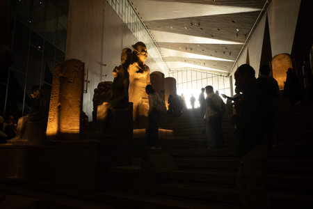Cairo, Egypt- February 01, 2026: Ancient Egyptian Statues and Relics Guarding the Grand Staircase...