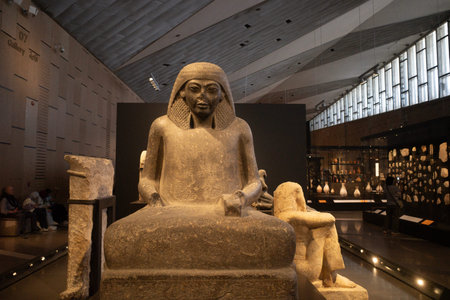 Cairo, Egypt- February 01, 2026: Ancient Egyptian Seated Limestone Statues and Kneeling Figures in...