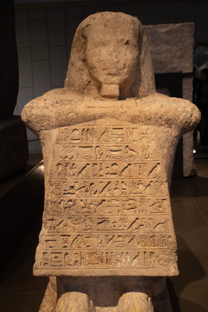 Cairo, Egypt- February 01, 2026: Ancient Egyptian Seated Limestone Statues and Kneeling Figures in...