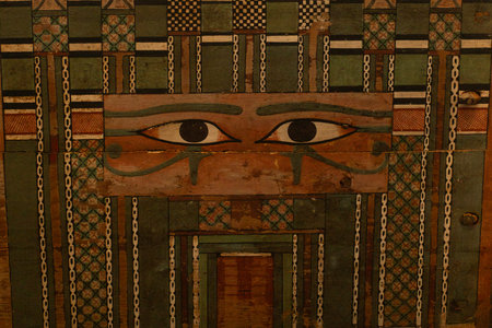 Decorative ancient egyptian-style panel with stylized eyes, geometric patterns, and weathered...