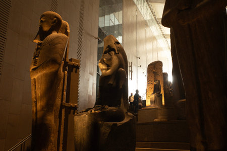 Cairo, Egypt- February 01, 2026: Ancient Egyptian Statues and Relics Guarding the Grand Staircase...