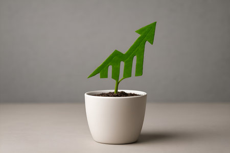 A small green plant in a white pot with a leaf shaped like a rising growth graph.の素材
