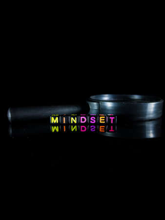 Selective focus.Word MINDSET from black dice with reflection on a black background.Shot were noise and film grain.の写真素材