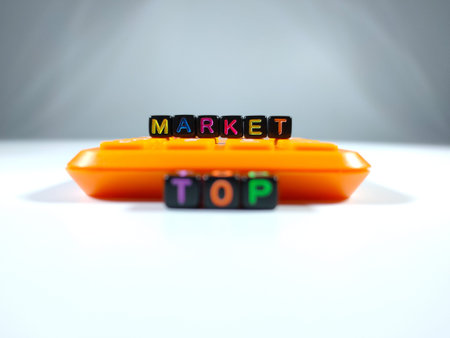 Selective focus.Word blur TOP MARKET from block dice with calculator on a white background.Business...