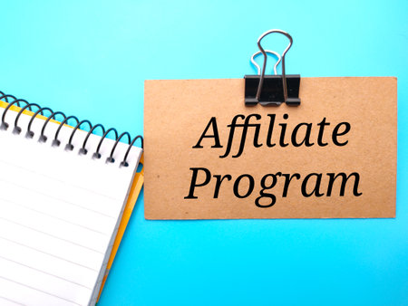 Hand holding colored wooden tangram written with text inflation on a yellow background.の写真素材