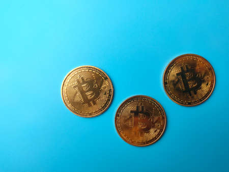 Shopping chart and golden bitcoin digital crypto coin on yellow background with copy space.の写真素材