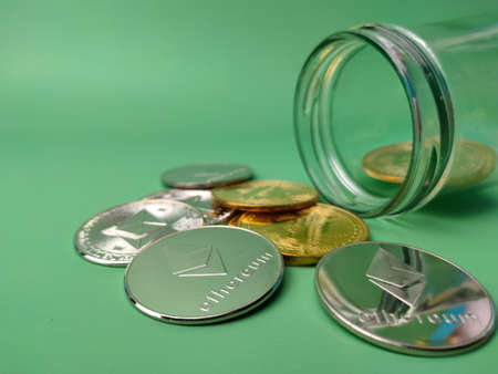 Top view colored board with text Crypto Base and silver ethereum and golden bitcoin digital crypto coin on yellow backgroundの写真素材