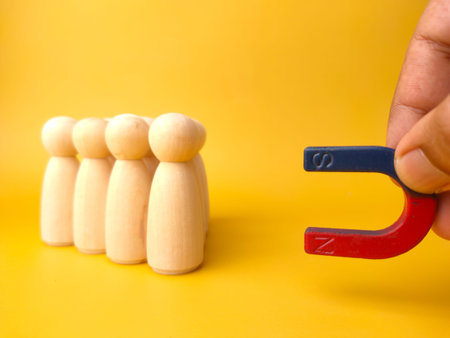 Wooden figures of people and a magnet. Team management concept. Human resources. Promote. Choosing a...