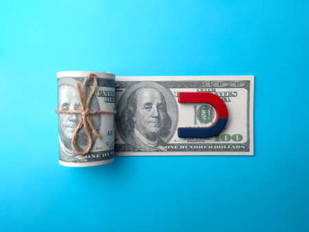 Dollar banknotes money and red blue magnet. Money launderingの写真素材