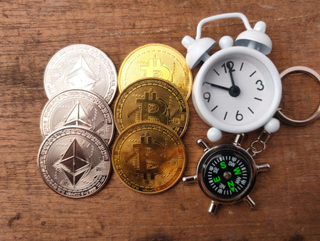 Top view coins and house keychain with text INVESTMENT on wooden background.