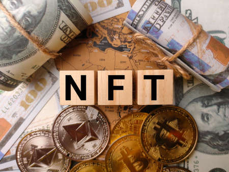 Top view banknotes and digital currency with text NFT on a world map background.の写真素材