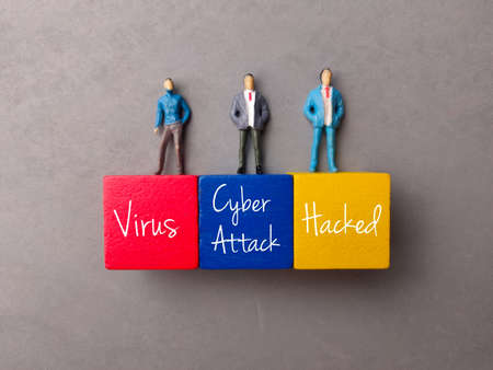 Hand holding yellow alarm clock on a blue background with copy space.の写真素材