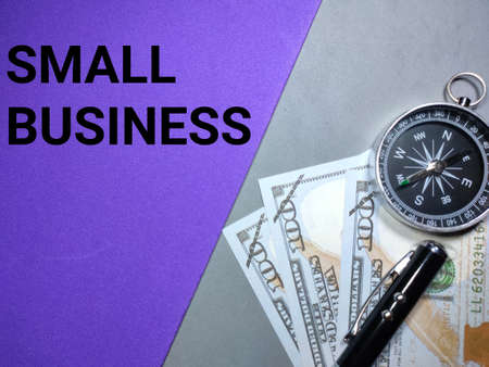 Selective focus.Pen,clock and banknote with word NON PROFIT on a purple and green background.Business concept,shot were noise and grain.の写真素材