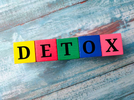 Colored wooden cube with word VERBAL on a blue background.の写真素材