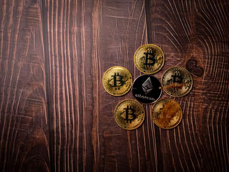 A five beautiful silver ethereum digital crypto coin on wooden table with copy space.の写真素材
