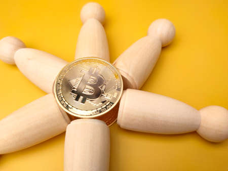 Bitcoins and world globe on a yellow background with copy space.の写真素材