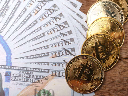 Bitcoins and world globe on a yellow background with copy space.の写真素材