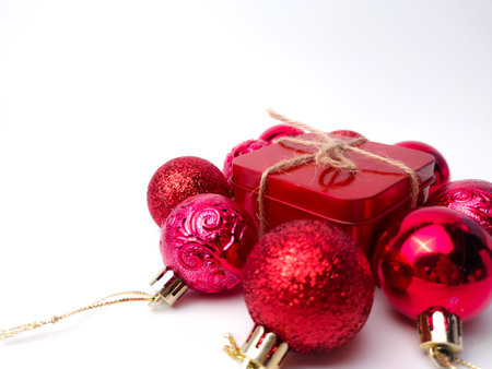 Christmas red ball and gifts box on a wooden table. Holidays christmas background. Copy space for text or design. View from above.の写真素材