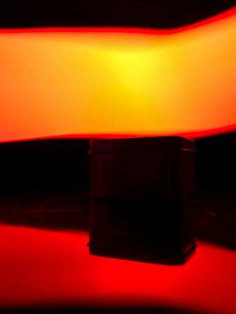 One gift wrapped in dark black paper on a white background.の写真素材