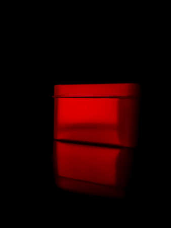 One gift wrapped in dark black paper on a white background.の写真素材